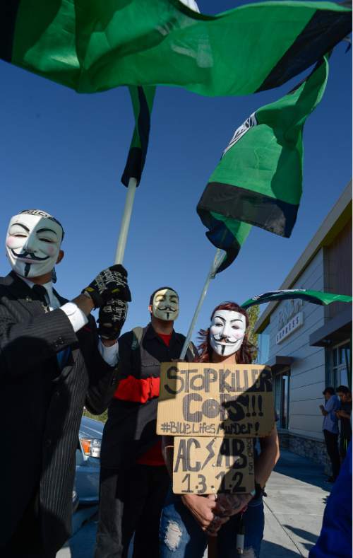 Francisco Kjolseth | The Salt Lake Tribune
The group known as Anonymous shows their support as they join those gathered nn the one-year anniversary of the death of Darrien Hunt at the hands of police in Saratoga Springs.