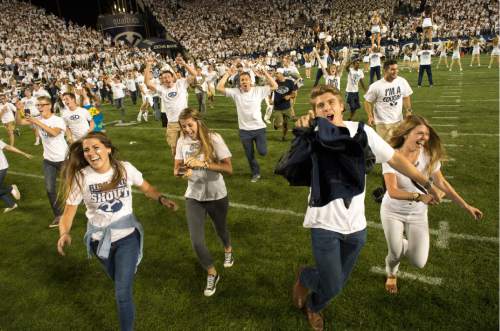 Rick Egan  |  The Salt Lake Tribune

Brigham Young fans storm the field as BYU upsets Boise State on two touchdowns in the last minute of play to beat the Broncos 35-24, in college football action, BYU vs. Boise State at Lavell Edwards Stadium, Saturday, September 12, 2015.