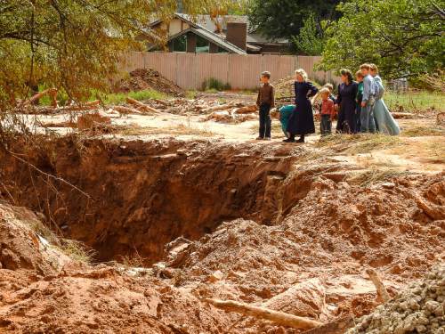 Trent Nelson  |  The Salt Lake Tribune
People take in the scene in a Hildale wash where a flash flood killed nine people (with four still missing) Tuesday September 15, 2015., the day after an SUV and a van were washed off a road during a flash flood in this polygamous Utah-Arizona border community.