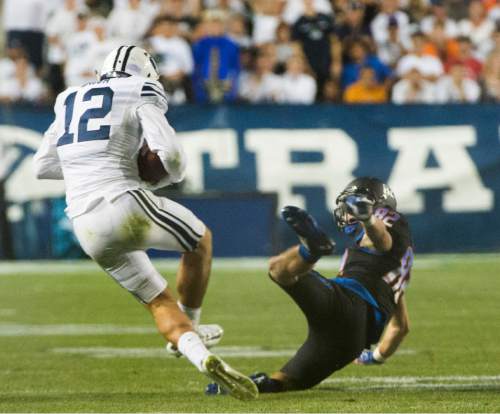 Rick Egan  |  The Salt Lake Tribune

Brigham Young defensive back Kai Nacua (12) snags a pass intended for Boise State Broncos wide receiver Thomas Sperbeck (82), for an  interception in the 4th quarter for the Cougars, in college football action, BYU vs. Boise State at Lavell Edwards Stadium, Saturday, September 12, 2015.