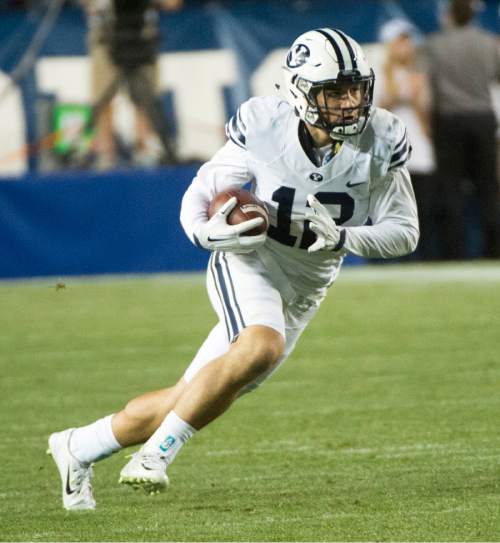 Rick Egan  |  The Salt Lake Tribune

Brigham Young Cougars defensive back Kai Nacua (12) runs for a touchdown after his interception, with just seconds remaining on the clock, in college football action, BYU vs. Boise State at Lavell Edwards Stadium, Saturday, September 12, 2015.