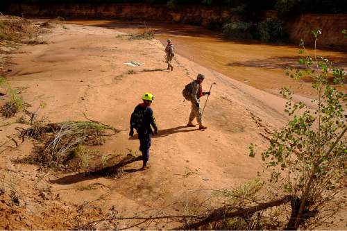 Trent Nelson  |  The Salt Lake Tribune
Members of the Utah National Guard and Task Force One search the Short Creek Wash in Hildale, Wednesday September 16, 2015. The Utah National Guard and law enforcement on Wednesday resumed searching for the last known victim of a flash flood that tore through this polygamous border town home to followers of Warren Jeffs, leaving 13 dead and three injured, all of them women and children.