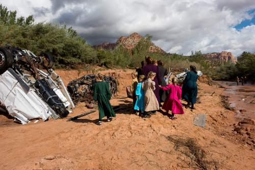 Trent Nelson  |  The Salt Lake Tribune
A group of FLDS women gather at the scene of the flash flood tragedy in Short Creek Wash in Hildale, Wednesday September 16, 2015. The Utah National Guard and law enforcement on Wednesday resumed searching for the last known victim of a flash flood that tore through this polygamous border town home to followers of Warren Jeffs, leaving 13 dead and three injured, all of them women and children.