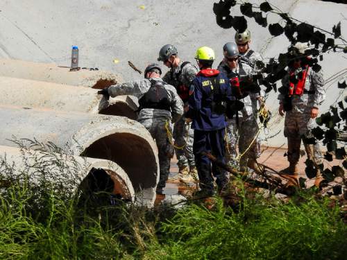 Trent Nelson  |  The Salt Lake Tribune
Searchers from the Utah National Guard and Task Force One search a culvert along the Short Creek Wash in Colorado City, Arizona, Wednesday September 16, 2015. The Utah National Guard and law enforcement on Wednesday resumed searching for the last known victim of a flash flood that tore through this polygamous border town home to followers of Warren Jeffs, leaving 13 dead and three injured, all of them women and children.