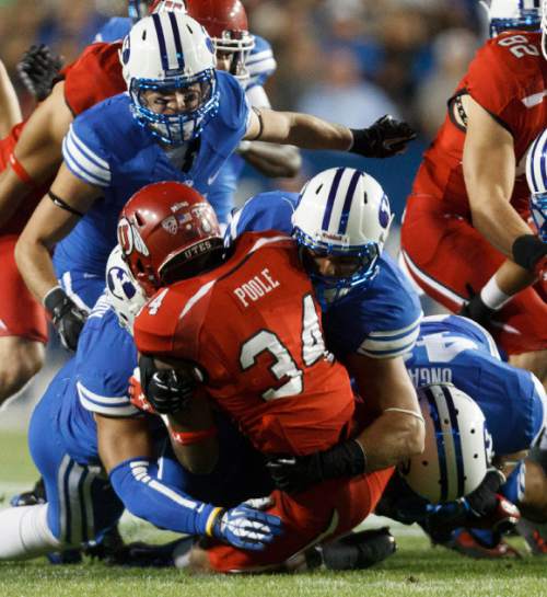 Trent Nelson  |  The Salt Lake Tribune
Utah Utes running back James Poole (34) is stopped by BYU defenders in the first quarter as the BYU Cougars host the Utah Utes, college football Saturday, September 21, 2013 at LaVell Edwards Stadium in Provo.