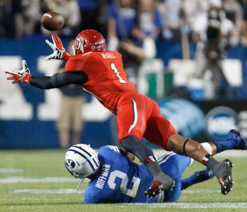 Trent Nelson  |  The Salt Lake Tribune
Utah Utes defensive back Keith McGill (1) leaps to intercept a BYU pass and comes up just short in the first quarter as the BYU Cougars host the Utah Utes, college football Saturday, September 21, 2013 at LaVell Edwards Stadium in Provo. Brigham Young Cougars wide receiver Cody Hoffman (2) at bottom.