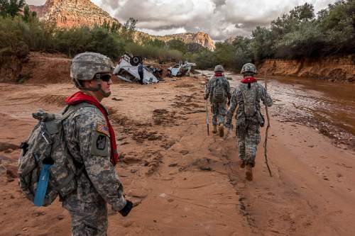 Trent Nelson  |  The Salt Lake Tribune
Members of the Utah National Guard search the Short Creek Wash in Hildale, Wednesday September 16, 2015. The Utah National Guard and law enforcement on Wednesday resumed searching for the last known victim of a flash flood that tore through this polygamous border town home to followers of Warren Jeffs, leaving 13 dead and three injured, all of them women and children.