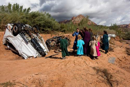 Trent Nelson  |  The Salt Lake Tribune
A group of FLDS women gather at the scene of the flash flood tragedy in Short Creek Wash in Hildale, Wednesday September 16, 2015. The Utah National Guard and law enforcement on Wednesday resumed searching for the last known victim of a flash flood that tore through this polygamous border town home to followers of Warren Jeffs, leaving 13 dead and three injured, all of them women and children.