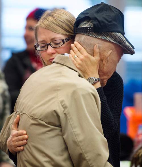 Steve Griffin  |  The Salt Lake Tribune

An emotional Jane Day, hugs her father, World War ll veteran Max Burdick, of Salt Lake City, during a song being sung at a morning briefing at the Utah State Senate Building, prior to the departure of a Utah Honor Flight to Washington, D.C., Salt Lake City, Thursday, September 17, 2015. The flight shuttled World War ll and Korean War Veterans to the nation's capital, where they will be given the opportunity to view memorials erected in memory of their service. Burdick, 92, was aboard the USS St. Louis during the Pearl Harbor invasion on Dec. 7, 1941.  The Utah House of Representatives raised $35,000 to sponsor the flight so the veterans could participate free of cost.