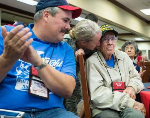 Steve Griffin  |  The Salt Lake Tribune

World War ll veteran Willard Mann, of Salt Lake City, gets a hug as he listens to instructions during a morning briefing at the Utah State Senate Building, prior to departure of a Utah Honor Flight from Salt Lake City, Thursday, September 17, 2015. The flight shuttled World War ll and Korean War Veterans to Washington, D.C., where they will be given the opportunity to view memorials erected in memory of their service.  The Utah House of Representatives raised $35,000 to sponsor the flight so the veterans could participate free of cost.