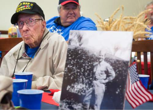 Steve Griffin  |  The Salt Lake Tribune

World War ll veteran Willard Mann, of Salt Lake City, listens to instructions during a morning briefing at the Utah State Senate Building, prior to departure of a Utah Honor Flight from Salt Lake City, Thursday, September 17, 2015. The flight shuttled World War ll and Korean War Veterans to Washington, D.C., where they will be given the opportunity to view memorials erected in memory of their service. A photograph of Mann from 1942, right, shows him in Boca Raton, FL prior to heading to Diss, England, where he was a radio gunner on B-17s and flew dangerous daylight mission dover Germany. The Utah House of Representatives raised $35,000 to sponsor the flight so the veterans could participate free of cost.