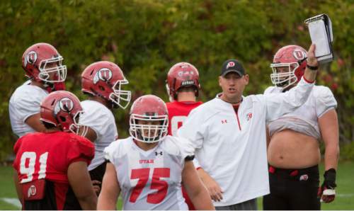 Steve Griffin  |  The Salt Lake Tribune

University of Utah football co-offensive coordinator Jim Harding holds up a play during practice at the Eccles Football Center on the University of Utah campus in Salt Lake City, Tuesday, September 15, 2015.
