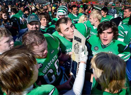 Scott Sommerdorf  |  The Salt Lake Tribune
South Summit players take turns kissing the 2A state championship trophy. South Summit won the title after beating Summit Academy 28-6 in Cedar City, Friday, November 14, 2014.