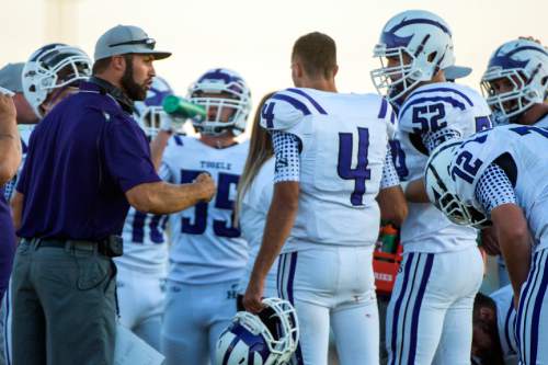 Chris Detrick  |  The Salt Lake Tribune
Tooele coach Kyle Brady talks with his younger brother Ryan Brady (4)  and the rest of the team during the game at Stansbury High School Friday September 11, 2015.