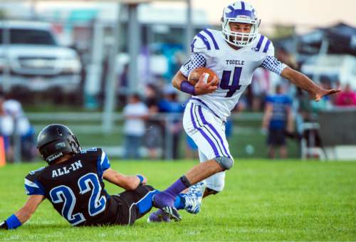 Chris Detrick  |  The Salt Lake Tribune
Tooele's Ryan Brady (4) runs past Stansbury's Casey Roberts (22) during the game at Stansbury High School Friday September 11, 2015.