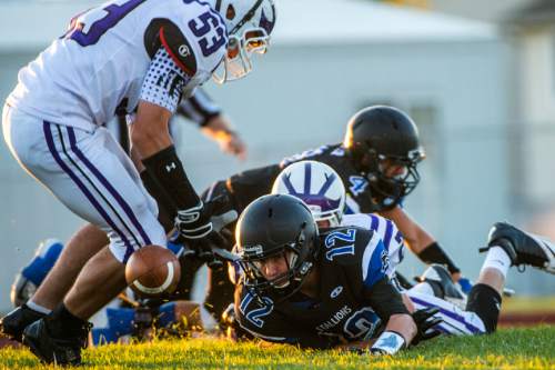 Chris Detrick  |  The Salt Lake Tribune
Tooele's Tysen Toone (53) recovers the fumble after Stansbury's Colton Christiansen (12) lost control of the ball during the game at Stansbury High School Friday September 11, 2015.