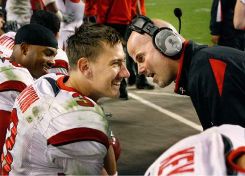 Scott Sommerdorf  |  Salt Lake Tribune

As the game nears the final seconds, Utah offensive coordinator Dave Schramm (right) stops by the bench to give freshman QB Jordan Wynn some words of encouragement. TCU defeated Utah 55-28 to stay undefeated and keep their BCS-busting hopes alive.
