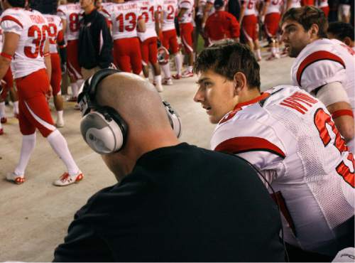 Scott Sommerdorf  |  Salt Lake Tribune

Utah quarterback Jordan Wynn #3 speaks with Offensive Coordinator Dave Schramm during first half play in the Poinsettia bowl on Wednesday December 23, 2009. Utah started slow, but came back to lead at half-time 24-14.