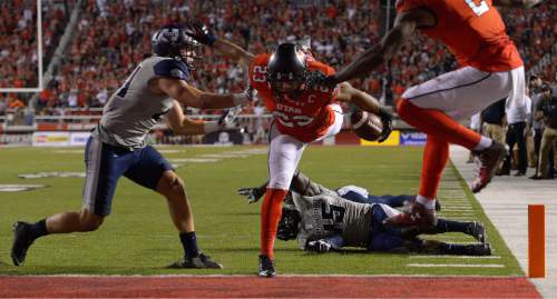 Leah Hogsten  |  The Salt Lake Tribune
Utah Utes running back Devontae Booker (23) with a touchdown. University of Utah is tied with Utah State 14-14 at halftime at Rice-Eccles Stadium, Friday, September 11, 2015.