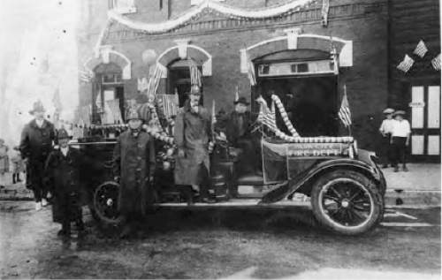 Salt Lake Tribune Archive

Park City Fire Department members posing with a decorated car in front of a decorated fire station.