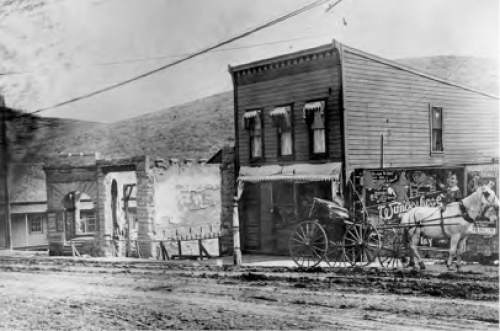 Salt Lake Tribune Archive

A horse and buggy stand in front of businesses along Park City, the remains of the a building at the left from the 1898 fire.