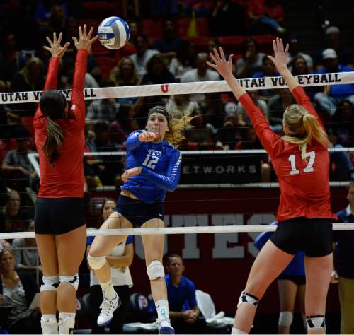 Francisco Kjolseth | The Salt Lake Tribune
BYU's Veronica Jones threads the ball between Utah players Eliza Katoa, left, and Brenna DeYoung in the annual meeting between the schools' women's volleyball teams at Utah.