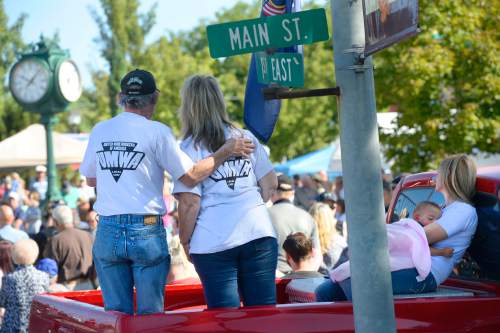 Al Hartmann  |  The Salt Lake Tribune
United Mine Workers family watches from the bed of their pickup truck the Carbon County Coal Miners' Memorial that was unveiled and dedicated Monday September 7 to coal miners that  died in accidents since the inception of mining in the 1880's.  Two statues and several large plaques with 1,400 names of miners now resides in the Price Peace Park along Main Street.