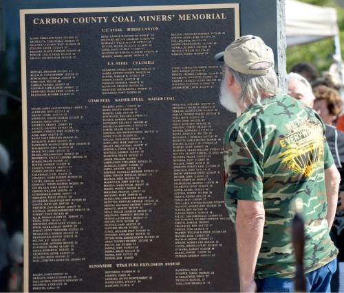 Al Hartmann  |  The Salt Lake Tribune
Folks take a close look for names of friends and relatives on the Carbon County Coal Miners' Memorial that was unveiled and dedicated Monday September 7 to coal miners that  died in accidents since the inception of mining in the 1880's.  Two statues and several large plaques with 1,400 names of fallen miners now resides in the Price Peace Park along Main Street.