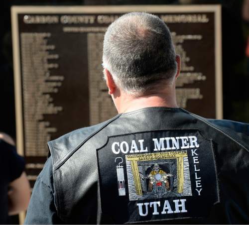 Al Hartmann  |  The Salt Lake Tribune
Folks take a close look for names of friends and relatives on the Carbon County Coal Miners' Memorial that was unveiled and dedicated Monday September 7 to coal miners that  died in accidents since the inception of mining in the 1880's.  Two statues and several large plaques with 1,400 names of fallen miners now resides in the Price Peace Park along Main Street.