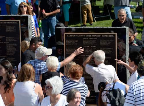 Al Hartmann  |  The Salt Lake Tribune
Folks take a close look for names of friends and relatives on the Carbon County Coal Miners' Memorial that was unveiled and dedicated Monday September 7 to coal miners that  died in accidents since the inception of mining in the 1880's.  Two statues and several large plaques with 1,400 names of fallen miners now resides in the Price Peace Park along Main Street.