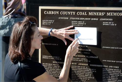 Al Hartmann  |  The Salt Lake Tribune
Michelle Goon makes a pencil etching of her little brother's name, James Smith who died in a mining accident on 1/25/1988. He was only 20.  His name is on the Carbon County Coal Miners' Memorial that was unveiled and dedicated Monday September 7 to coal miners that died in accidents since the inception of mining in the 1880's.  Two statues and several large stone plaques with 1,400 names of fallen miners now resides in the Price Peace Park along Main Street.