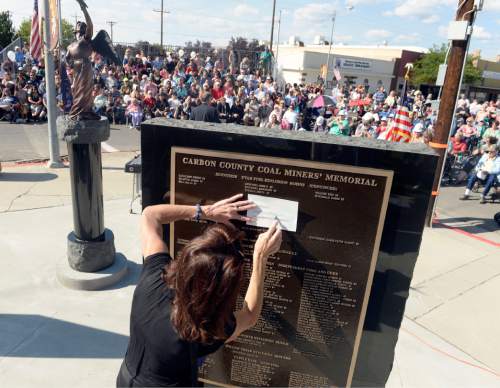 Al Hartmann  |  Tribune file photo
Michelle Goon makes a pencil etching of her little brother's name, James Smith who died in a mining accident on 1/25/1988. He was only 20.  His name is on the Carbon County Coal Miners' Memorial that was unveiled and dedicated last September in Price. A similar monument will be dedicated Saturday In Castle Dale to honor people killed in Emery County mines.