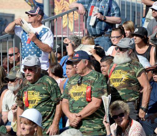 Al Hartmann  |  The Salt Lake Tribune
Miners in the crowd stand to be recognized at the Carbon County Coal Miners' Memorial that was unveiled and dedicated Monday September 7 to coal miners that  died in accidents since the inception of mining in the 1880's.  Two statues and several large plaques with 1,400 names of fallen miners now resides in the Price Peace Park along Main Street.