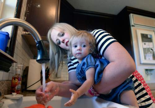 Al Hartmann  |  The Salt Lake Tribune
Anna Reeder washes her daughter Mitzi's hands before breakfast at their home in Logan.  The family participates in the National Children's Study, a much trumpeted nationwide study that was supposed to involve thousands of American children. The University of Utah was one of the research sites, and it enlisted hundreds of Utah families to help. But the national study was disbanded last winter. Now, the U. researchers are going ahead with the Utah Children's Study, and the Reeder family is one of the families in which the children's health is being carefully monitored.