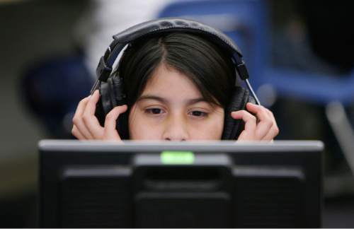 Francisco Kjolseth  |  The Salt Lake Tribune    
West Valley City - Reyna Zarate, 10, a students at Granger Elementary in West Valley City concentrates on a 7-minute computer session three times a week meant to strengthen reading skills.  The computer program called eyeQ Education was created by a Utah company, and is meant to increase fluency and comprehension, but also physically strengthen the eyes through a series of exercises.