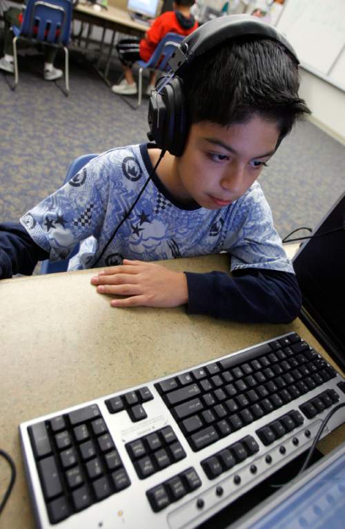Francisco Kjolseth  |  The Salt Lake Tribune    
West Valley City - Jorge Castro, 11, a student at Granger Elementary in West Valley City tries to read a paragraph as quickly as possible while working on a 7-minute computer session. The session done three times a week are meant to strengthen kids reading skills.  The computer program called eyeQ Education was created by a Utah company, and is meant to increase fluency and comprehension, but also physically strengthen the eyes through a series of exercises.
