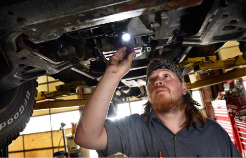 Scott Sommerdorf   |  The Salt Lake Tribune
Justin Watson, a mechanic at The Mechanic Man, examines a 2001 Chevrolet Suburban that was in for repairs, Thursday, September 17, 2015.