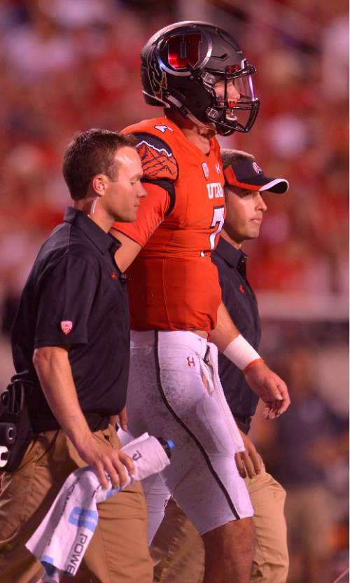 Leah Hogsten  |  The Salt Lake Tribune
Utah Utes quarterback Travis Wilson (7) leaves the game after an injury. University of Utah is tied with Utah State 14-14 at halftime at Rice-Eccles Stadium, Friday, September 11, 2015.