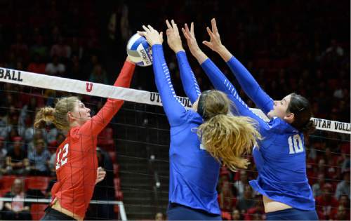 Francisco Kjolseth | The Salt Lake Tribune
Utah's Berkeley Oblad tries to break through the BYU defense of  Veronica Jones, center, and Amy Boswell as Utah hosts No. 9 BYU in the annual meeting between the schools' women's volleyball teams.