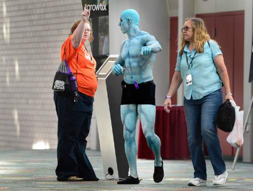 Scott Sommerdorf   |  The Salt Lake Tribune
"Dr. Manhattan" from the graphic novel miniseries "Watchmen" stops to get directions from a volunteer at ComicCon, Saturday, September 26, 2015.