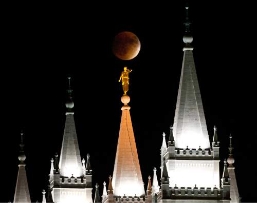 Lennie Mahler  |  The Salt Lake Tribune

The supermoon rises as it simultaneously is eclipsed over the LDS Temple in Salt Lake City, Utah. Sunday, Sept. 27, 2015.