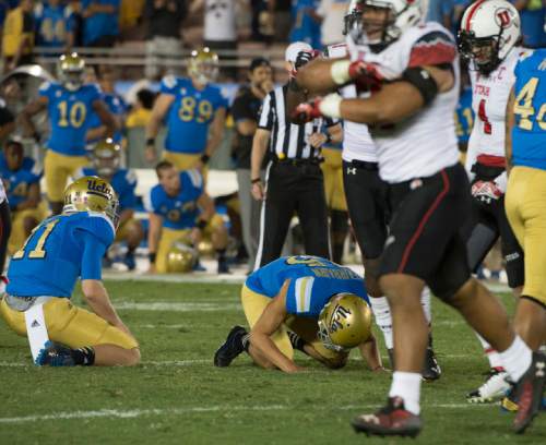 Rick Egan  |  The Salt Lake Tribune

UCLA Bruins quarterback Jerry Neuheisel (11) Bruins place kicker Ka'imi Fairbairn (15) react as the Fairbarin's kick with no is not good, with no time left on the clock, at the Utes upset UCLA 30-28  in Pac 12 action, at the Rose Bowl, Saturday, October 4, 2014