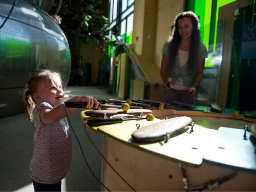 Lennie Mahler  |  The Salt Lake Tribune

Kami Hepworth watches her daugher, Ava, play a mallet instrumemnt in the Garden at Discovery Gateway Children's Museum on Friday, Sept. 25, 2015.