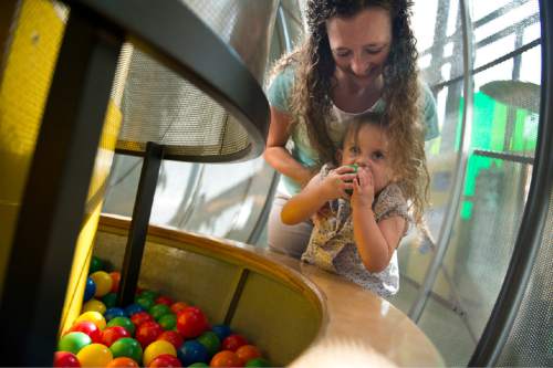 Lennie Mahler  |  The Salt Lake Tribune

Kami Hepworth helps her daughter, Ava, reach into the ball pit in the Garden at Discovery Gateway Children's Museum on Friday, Sept. 25, 2015.