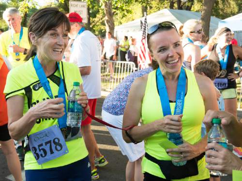 Rick Egan  |  The Salt Lake Tribune

Becky Andrews shares a laugh with her guide, Alanna Whetsel at the finish line, after the completed the Deseret News 10K.  Whetsel was Becky's guide when they ran the New York Martahon last year. Friday, July 31, 2015.