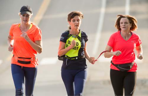 Rick Egan  |  The Salt Lake Tribune

L-R Suzette Hirst, Becky Andrews, and Brenda Petersen.  Hirst and Peterson ran as Becky's guide in the Boston Marathon, and take turns guiding her, nearly everyday, as they run in their Bountiful neighborhood. Friday, July 23, 2015.