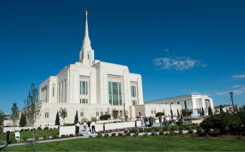 Rick Egan  |  The Salt Lake Tribune

Guests take photos and explore the grounds of the Ogden Temple, on the first day of the public open house, Friday, August 1, 2014.  The temple will be formally rededicated in three sessions on Sunday, September 21, 2014