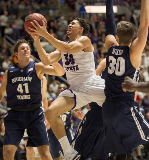 Rick Egan  |  The Salt Lake Tribune

Weber State Wildcats guard Jeremy Senglin (30), splits the defenders, in basketball action BYU vs Weber State, at the Dee Events Center in Ogden, Saturday, December 13, 2014