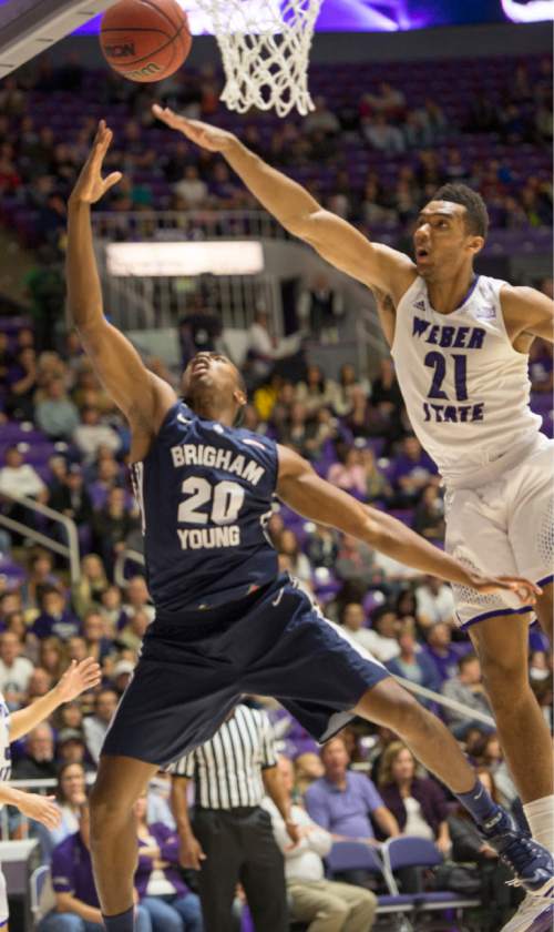 Rick Egan  |  The Salt Lake Tribune

Brigham Young Cougars guard Anson Winder (20) takes the ball to the hoop, as Weber State Wildcats forward Joel Bolomboy (21) defends in basketball action BYU vs Weber State, at the Dee Events Center in Ogden, Saturday, December 13, 2014