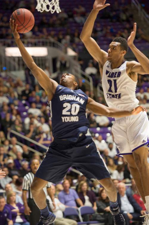 Rick Egan  |  The Salt Lake Tribune

Brigham Young Cougars guard Anson Winder (20) takes the ball to the hoop, as Weber State Wildcats forward Joel Bolomboy (21) defends in basketball action BYU vs Weber State, at the Dee Events Center in Ogden, Saturday, December 13, 2014